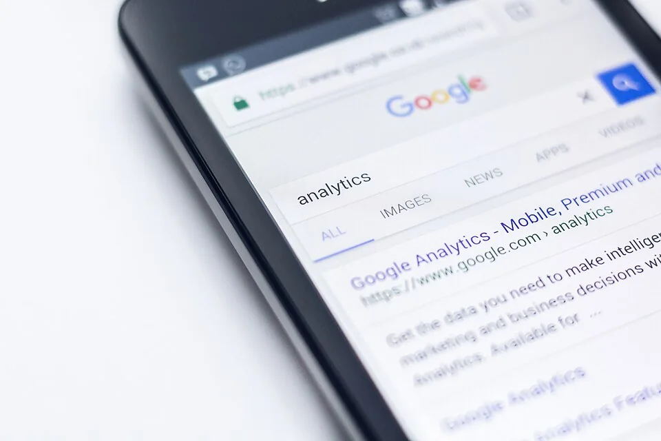 A close view of a smartphone showing a web search for analytics.